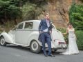 vride and groom by wedding car in Leeds